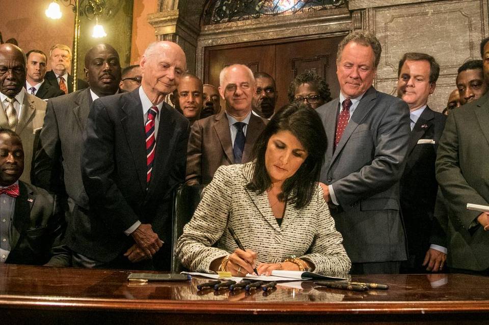 On July 9, 2015, South Carolina Governor Nikki Haley signed a bill ordering the removal of the Confederate battle flag flying on the State House grounds in Columbia, South Carolina. (Photo by Tim Dominick, The State)